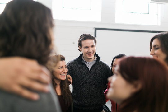 Group Of People With Their Arms Around Each Other