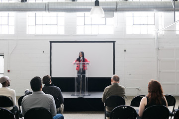 Young woman giving a presentation in an auditorium