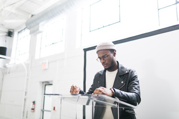 Fototapeta premium Young man delivering a presentation from a podium