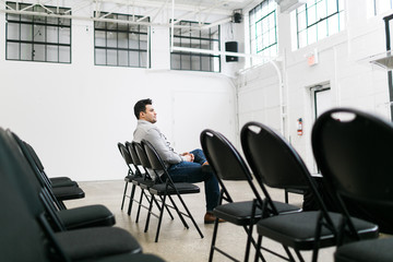 Young man sitting in an auditorium