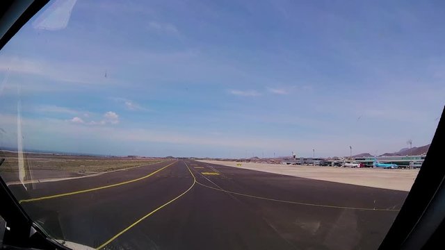 commercial airplane rolling down an airport runway. subjective view