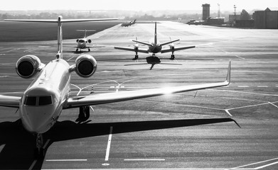 Private jet planes on the landing line in the morning time.Black and white.