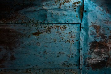 Dark wall is covered with tin.