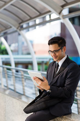 Fototapeta premium Young asian businessman working outdoors