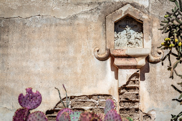 A Station of the Cross in the mortuary chapel courtyard of mission San Xavier del Bac near Tucson, Arizona.