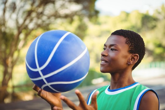 Smiling Young Man Playing With Basketball