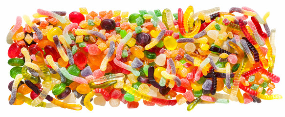 panorama close up a background from colorful sweets of sugar candies and marmalade.