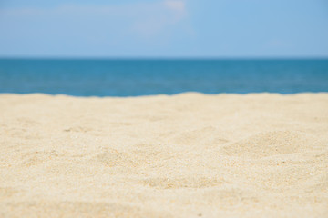 Fototapeta na wymiar Closeup of sand on the beach and blue sky background