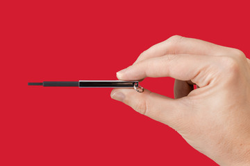 Black flash memory on hand with isolated red background