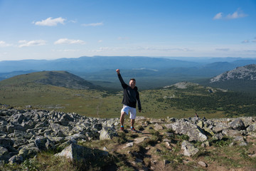 a man takes pictures at the top of a mountain