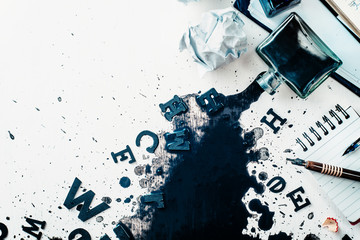 Header with spilled ink, crumpled paper, scattered letters, papers and notepads on a white wooden background. Creative writing concept. Flat lay with copy space. - obrazy, fototapety, plakaty