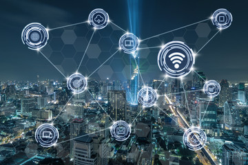 Wireless communication connecting of smart city Internet of Things Technology over the Top view of Bangkok Cityscape at night, Mahanakhon, technology business IOT concept