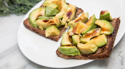 Sliced avocado sandwich butterbrod with glaze vinegar