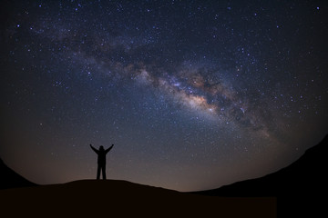 Panorama landscape with milky way, Night sky with stars and silhouette of a standing sporty man...