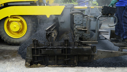 Asphalting paver machine during Road street repairing works