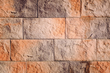 Fragment of a wall from a decorative brick.