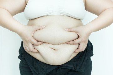 Fat overweight woman pinching her fat tummy.
