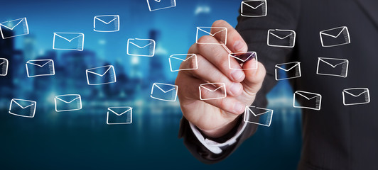Businessman drawing floating emails sketch