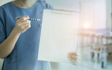 Doctor or nurse  holding a medical chart.
