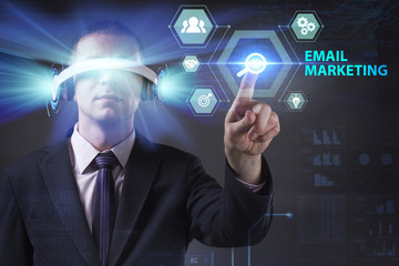 Business, Technology, Internet and network concept. Young businessman working in virtual reality glasses sees the inscription: Email marketing