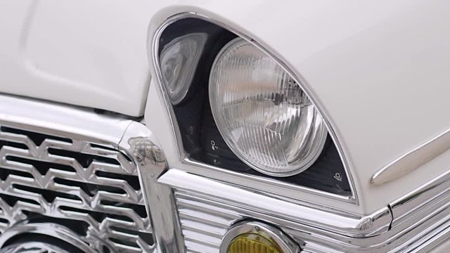 classic white retro machine. headlights close-up. slow motion