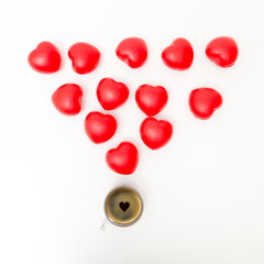 Cup of coffee with hearts on white table. Top view with copy space. Valentine's day background