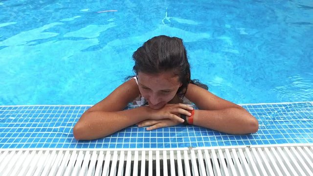 beautiful teen girl refresh in luxury pool,  steadicam