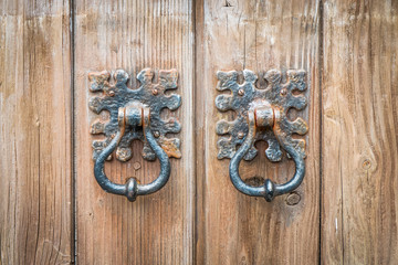 Ancient door knocker on a wooden door