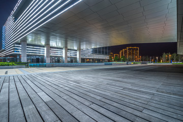 Empty wooden footpath front modern building.