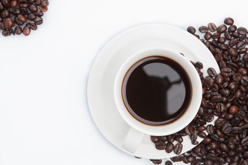 Cup of coffee on beans.