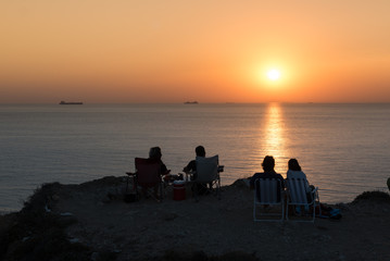 Fototapeta na wymiar Unidentified people wait for sunset at Bozcaada,Turkey