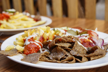 Strips of fried meat with fried potatoes and ketchup