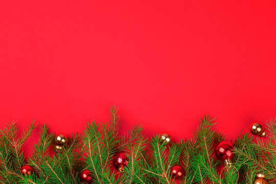 Christmas background with xmas tree and balls on red background. Merry christmas card. Winter holiday theme. Happy New Year. Space for text