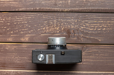 Old retro camera on wooden table background