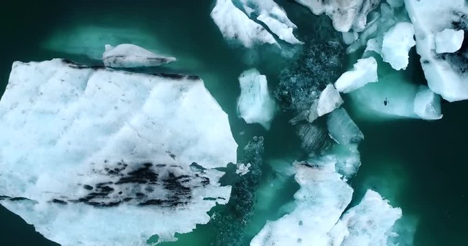 Aerial flight with drone over the of icebergs floating in Jokulsarlon