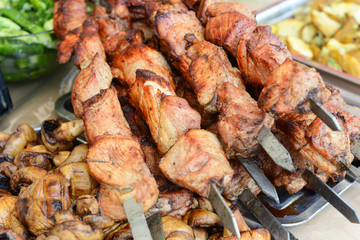 Marinated shashlik preparing on a barbecue grill over charcoal. Shashlik or Shish kebab popular in Eastern Europe. Roast Beef Kebabs On BBQ Grill. Shashlyk (skewered meat)