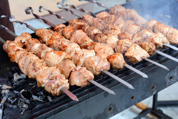 Marinated shashlik preparing on a barbecue grill over charcoal. Shashlik or Shish kebab popular in Eastern Europe. Roast Beef Kebabs On BBQ Grill. Shashlyk (skewered meat)