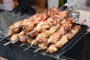 Marinated shashlik preparing on a barbecue grill over charcoal. Shashlik or Shish kebab popular in Eastern Europe. Roast Beef Kebabs On BBQ Grill. Shashlyk (skewered meat)