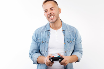 Young man grimacing after losing in video game