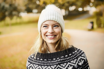 Woolly hat girl with long blond hair, smiling