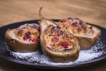 Homemade baked pears with cottage cheese, honey, red cranberries and walnuts, close up