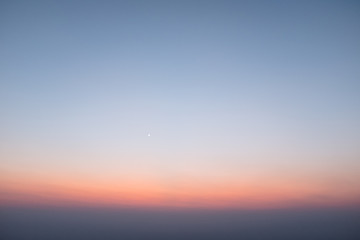 Sunset scene on hight mountain. Sunshine through the clouds. silhouette at the mountain.