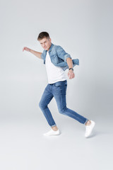 Fototapeta na wymiar handsome man in jeans and jacket jumping