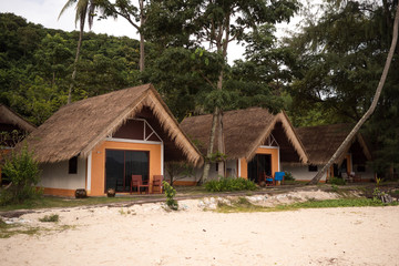 Fototapeta na wymiar Bungalows are located in the depths of the island among the jungles of Thailand Koh He 