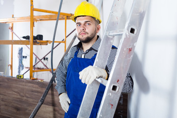 Portrait of smiling workman which is plastering