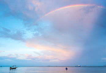 Rainbow and cloudy blue sky