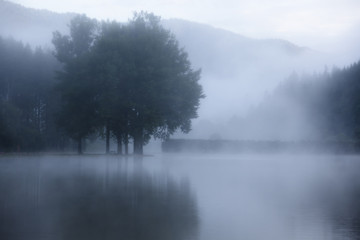 Fototapeta na wymiar Lake at foggy morning misty weather