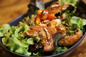 Chicken salad on wood background in restaurant lgiht