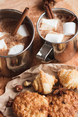 Metal mugs with cacao and marshmallow