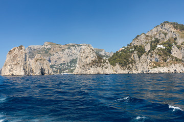 Fototapeta na wymiar View from the boat on the cliff coast of Capri Island. Italy